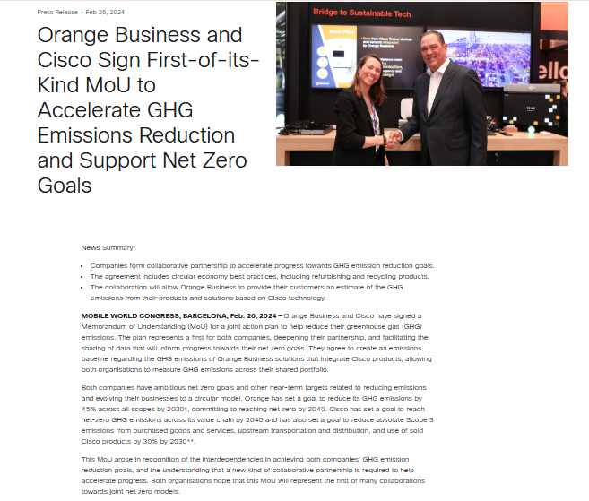 Two business professionals stand smiling and shaking hands in front of a display screen, marking the signing of a collaborative MoU between Orange Business and Cisco on GHG emissions reduction.